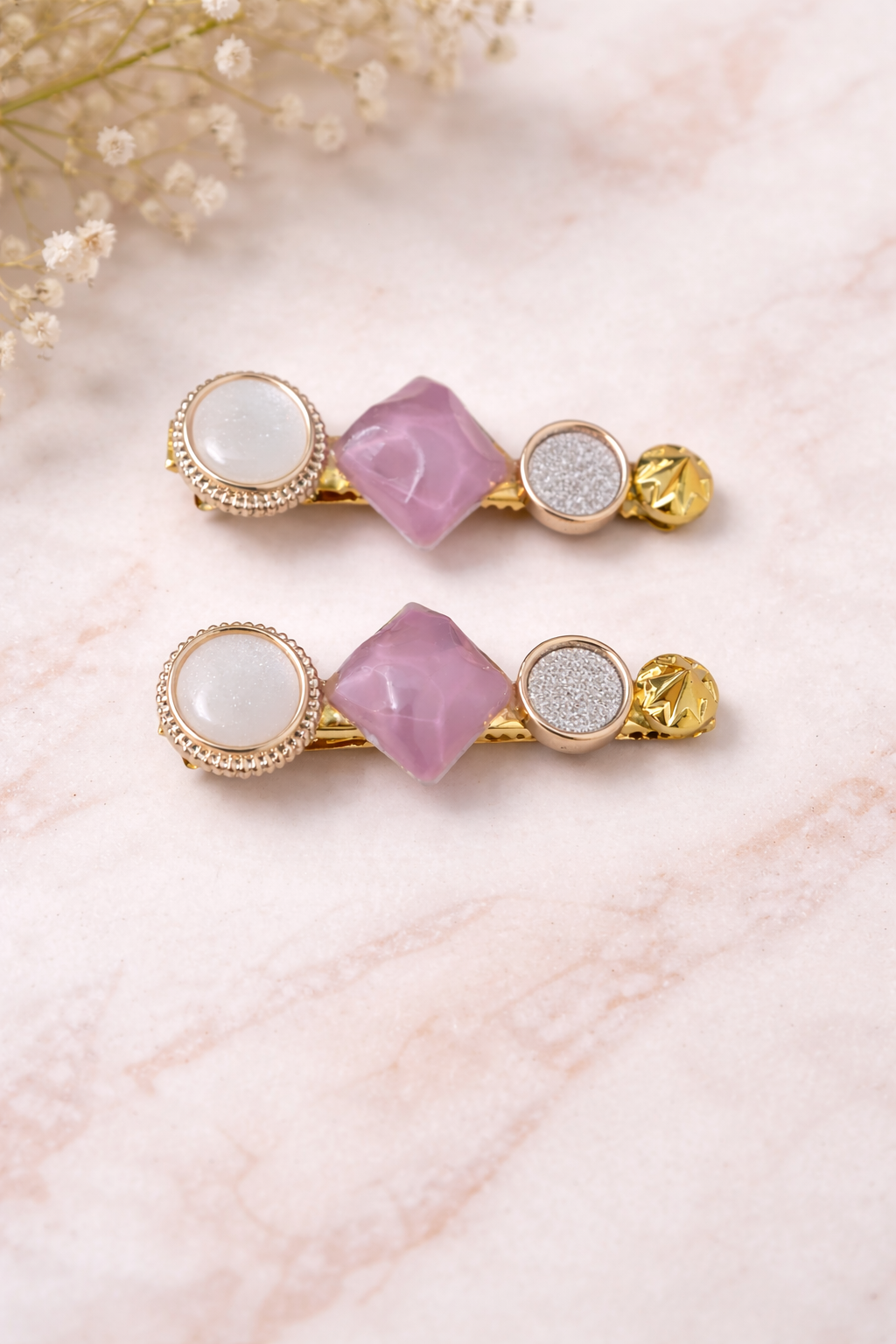 The hair clip on a pink marble background 