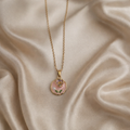 The pendant on a rose cloth background 