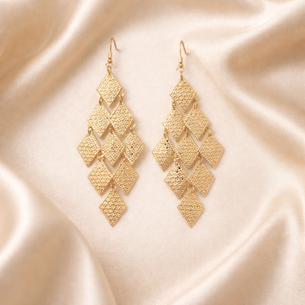 The earrings on a beige cloth background 
