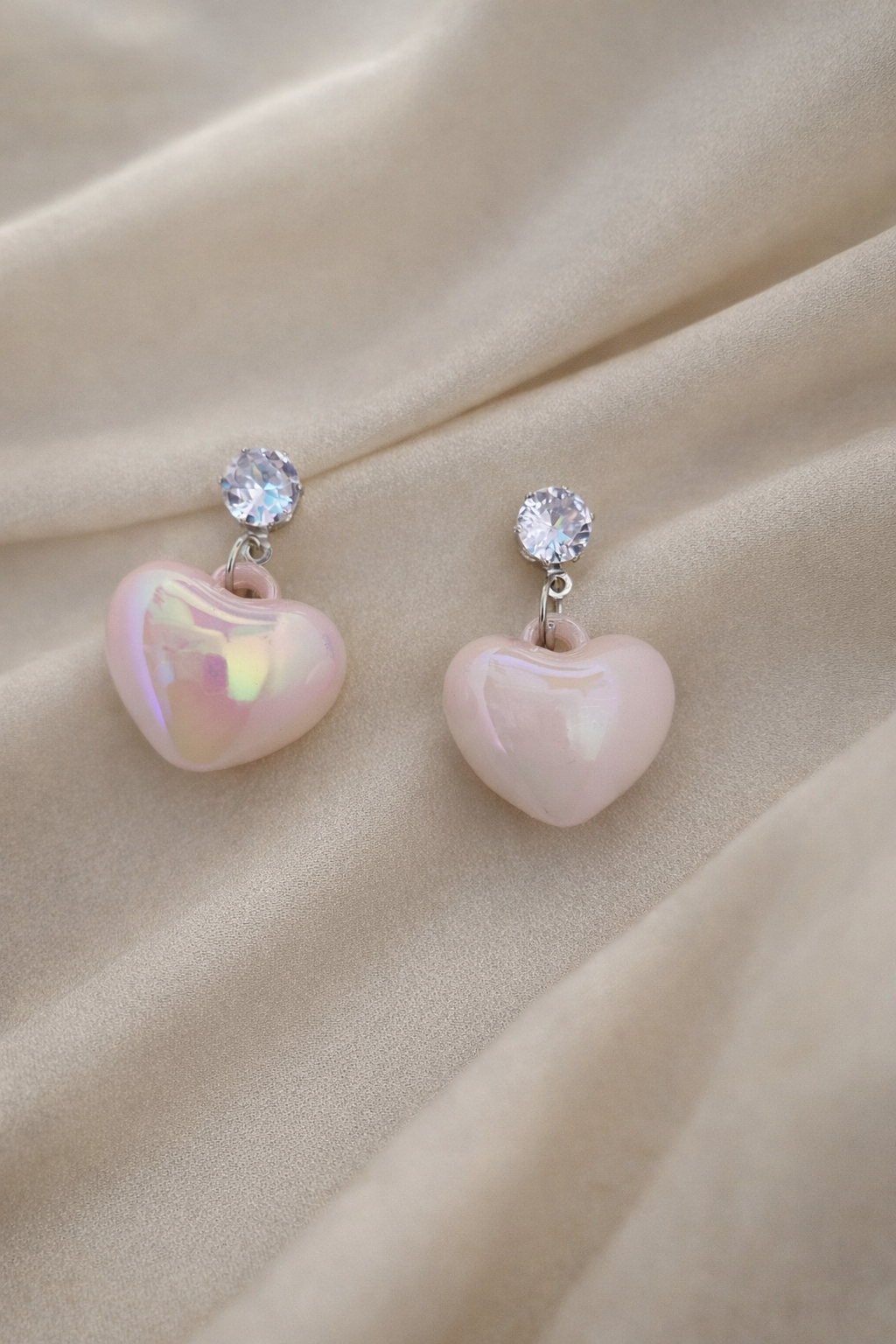 The earrings on a rose cloth background 