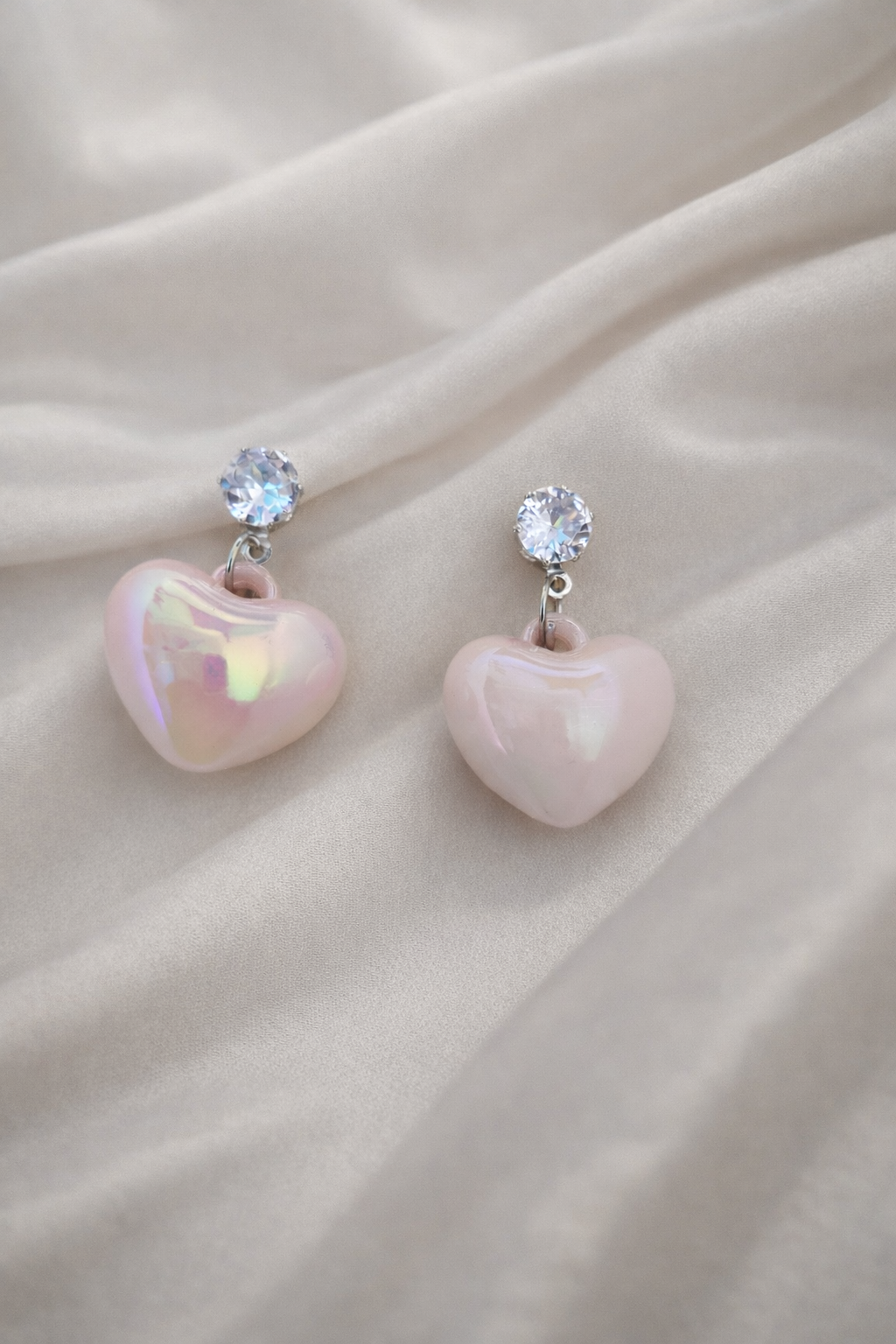 The earrings on a white cloth background 