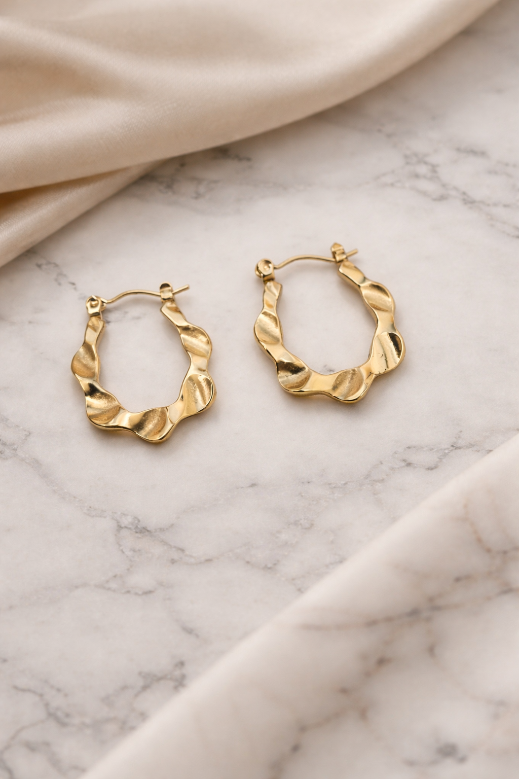 The earings on a white marble background