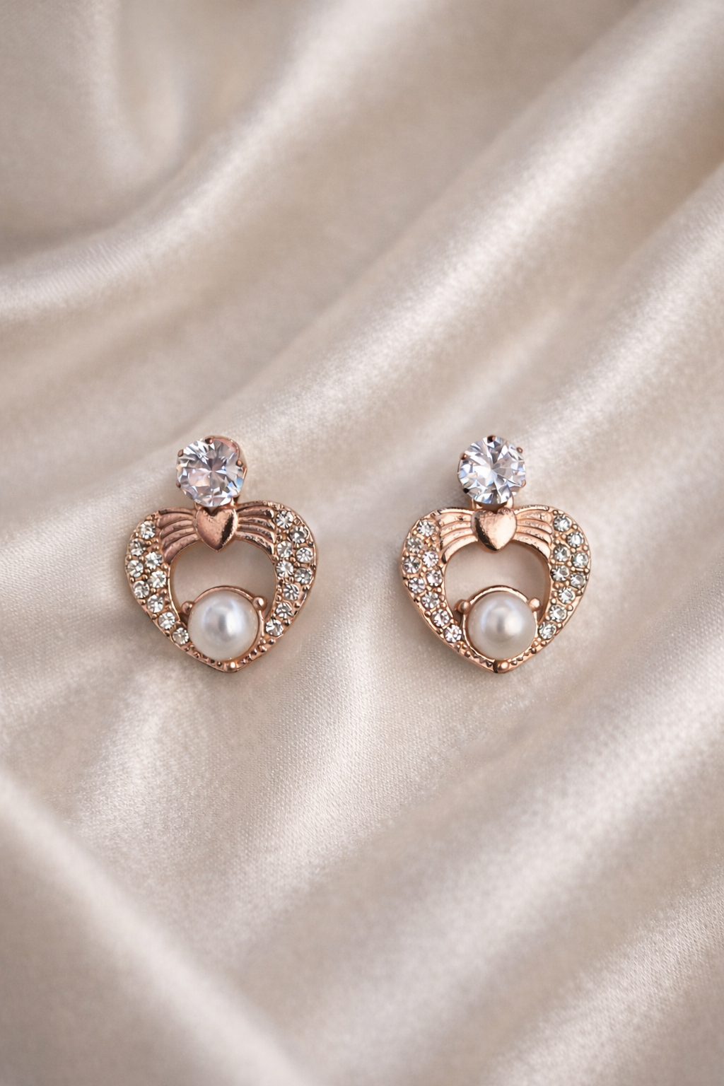 The earings on a rose cloth background 