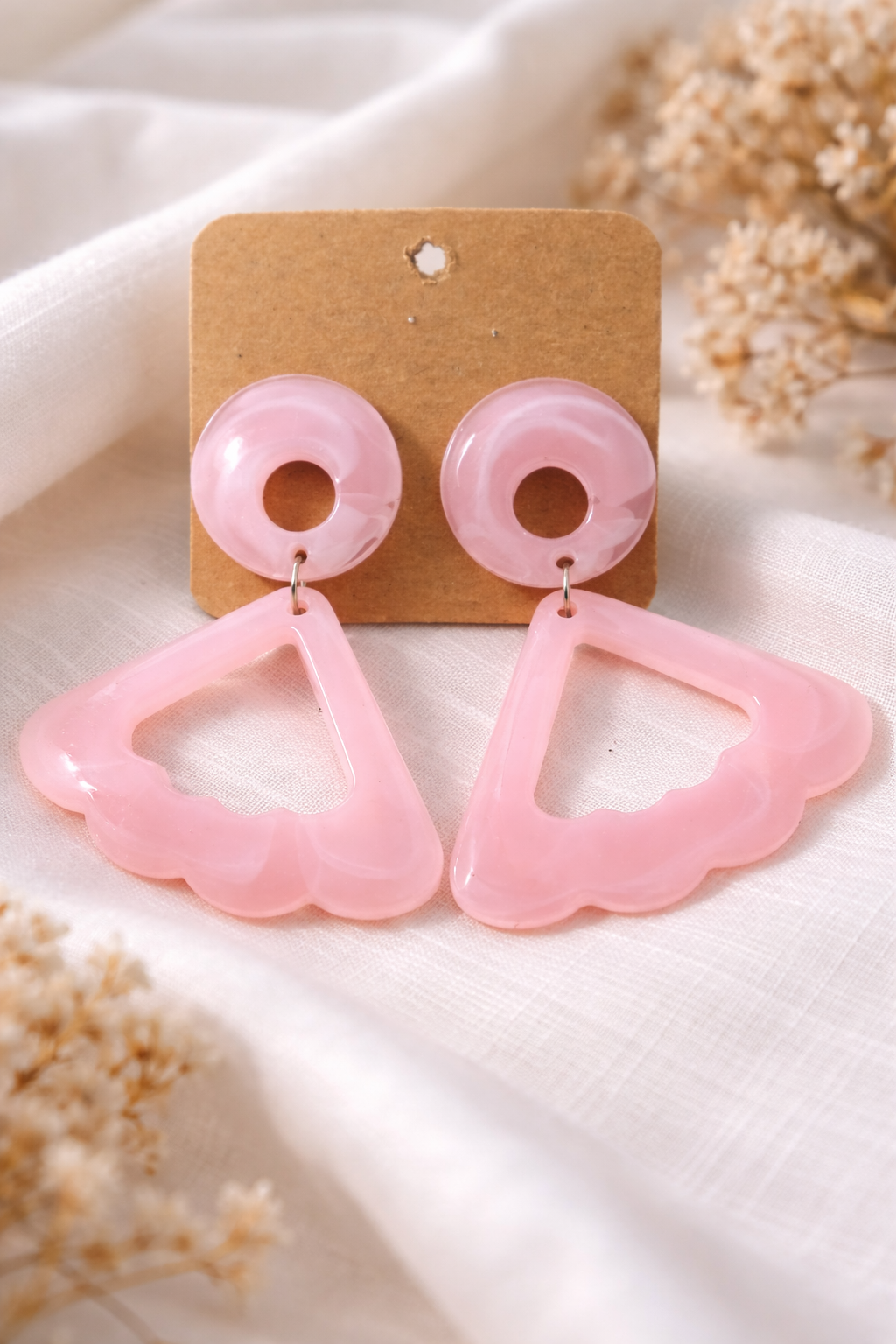 The earrings on a white cloth background 