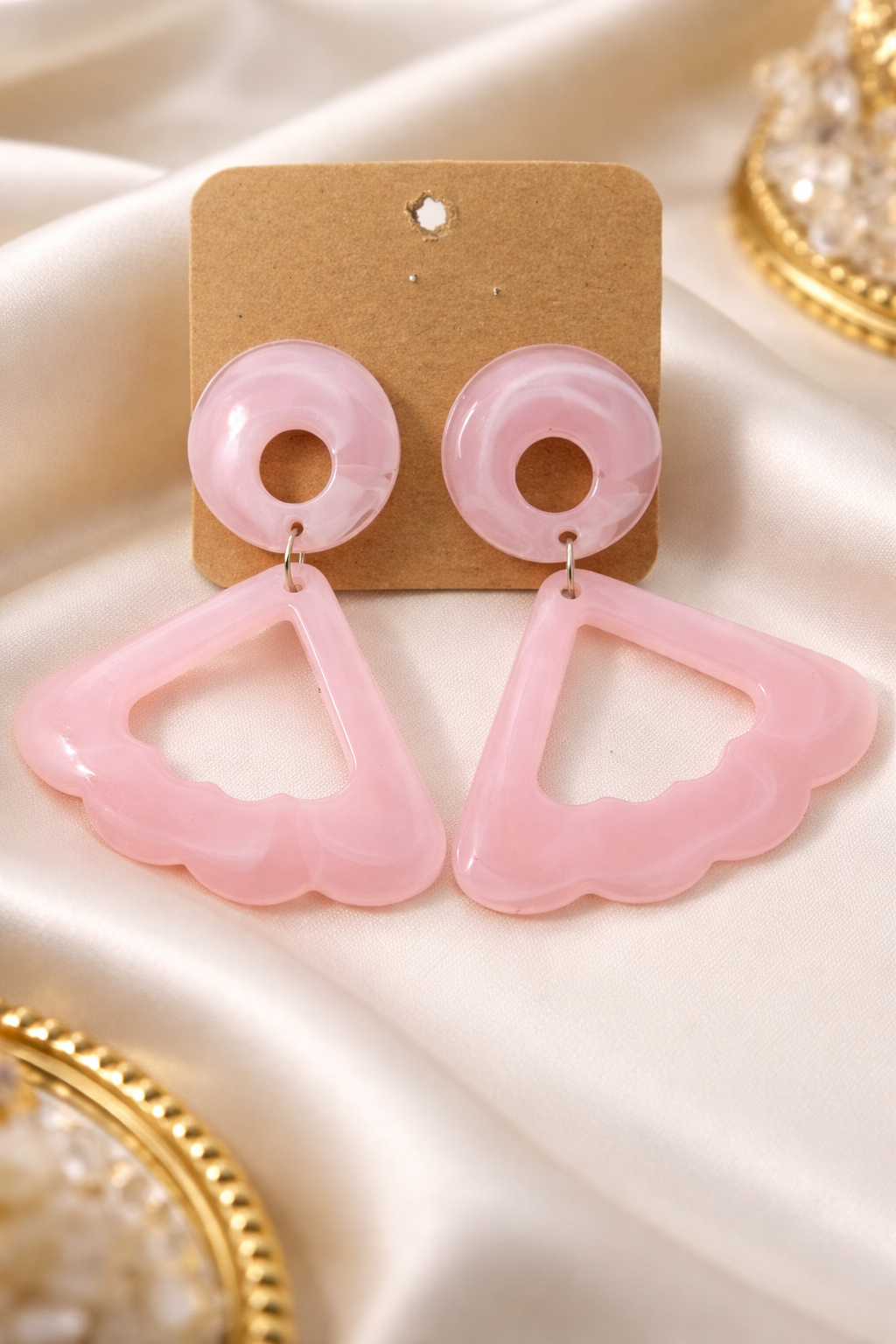 The earrings on a white cloth background 