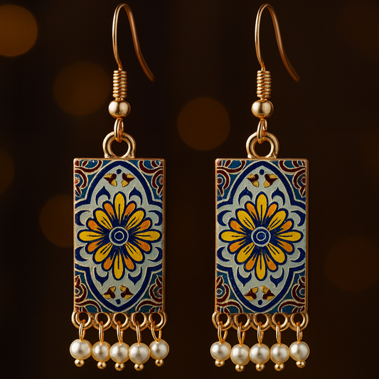 Decorative earrings with floral design and pearl accents on a dark background