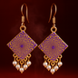 A pair of handcrafted square-shaped dangle earrings featuring intricate purple and gold mandala designs, accented with clusters of small white faux pearls