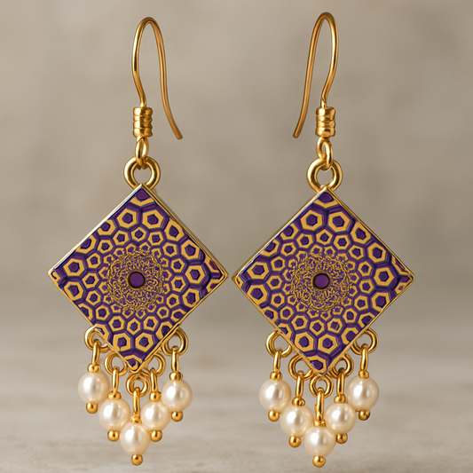 A pair of handcrafted square-shaped dangle earrings featuring intricate purple and gold mandala designs, accented with clusters of small white faux pearls