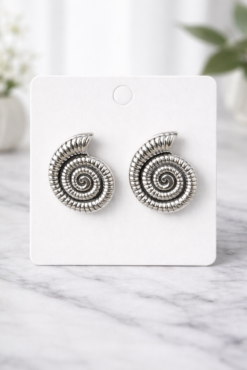 The earrings on a marble background 