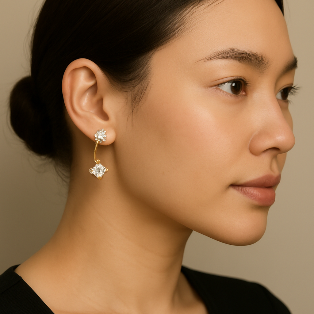 Close-up of a woman wearing gold earrings with a beige background