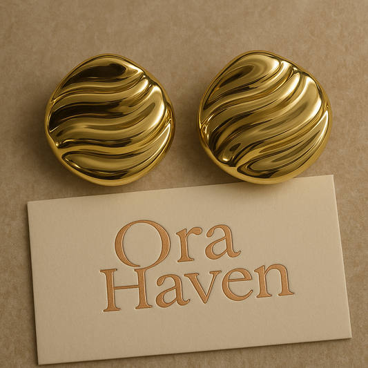 Sunset Flow gold wave earrings with elegant wavy design on a premium marble background – Ora Haven Jewelry