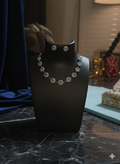 Jewelry set on a black mannequin bust with a blurred background