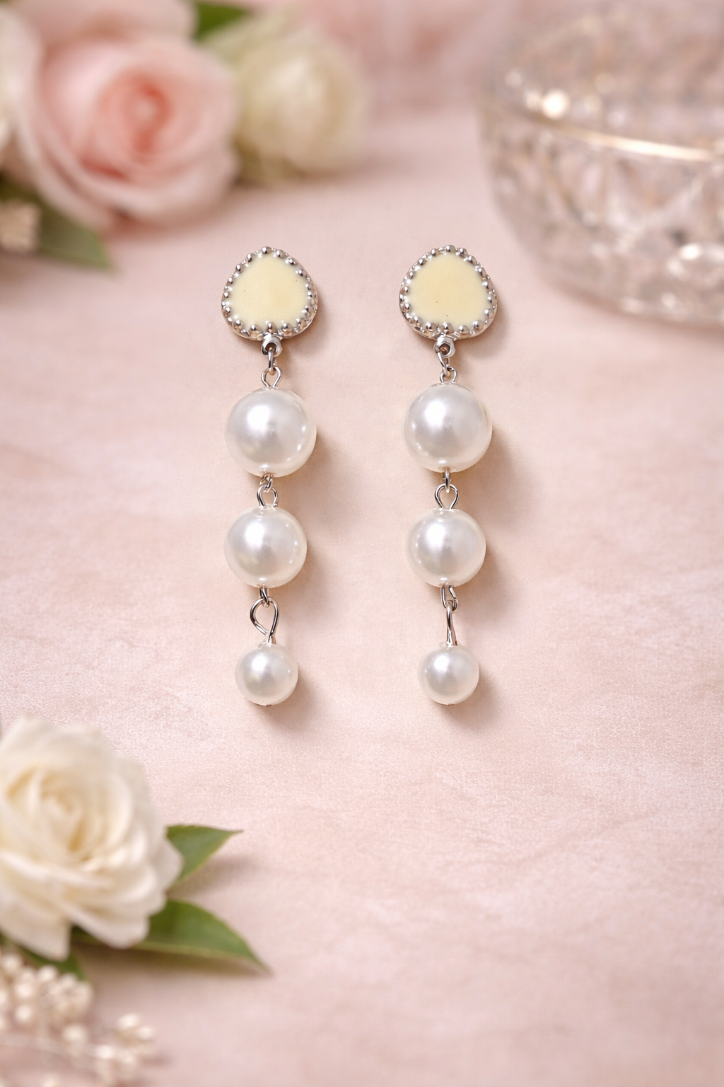 The earrings on a pink background 