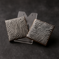 Pair of square earrings with black and white wavy zebra stripe patterns