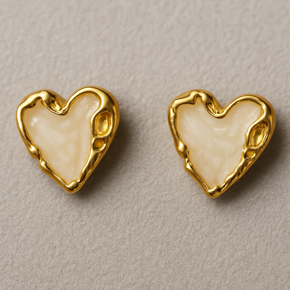 Pair of heart-shaped stud earrings with glossy Ivory enamel centers and textured gold-toned edges