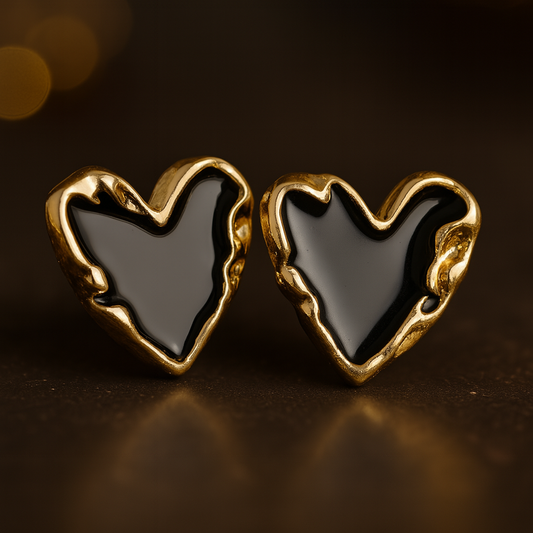 Pair of heart-shaped stud earrings with glossy black enamel centers and textured gold-toned edges
