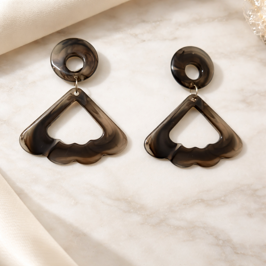 The earings on a white marble background 