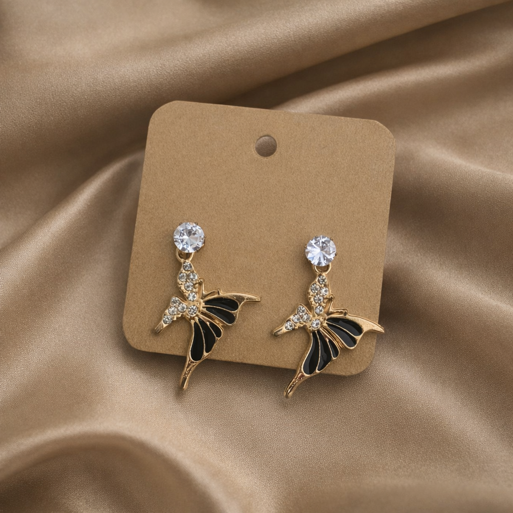 The earrings on a golden color background 