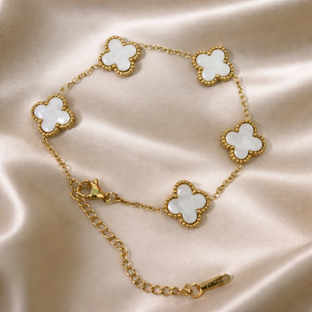 golden bracelet with 5 glossy white clover charms.