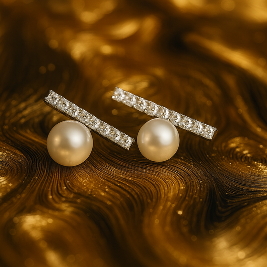 Elegant stud earrings featuring a row of sparkling crystals set in a horizontal bar above a single round pearl